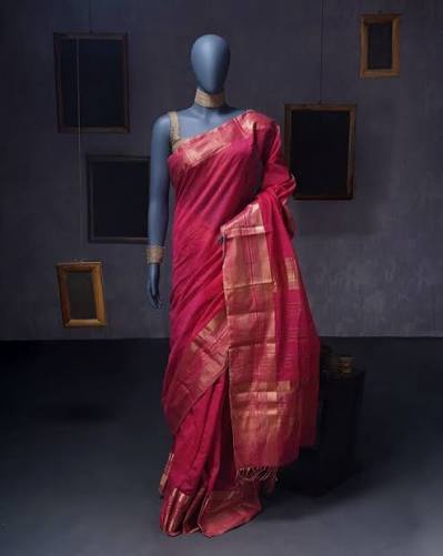 Crimson silk saree with gold zari border draped on a mannequin