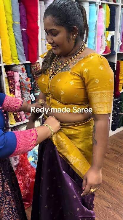 Client being fitted for a mustard blouse and purple saree in the studio